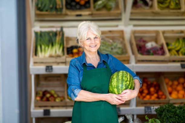 istock Senior woman working in small grocery store 1142637543
