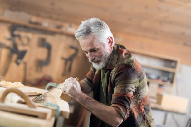 istock Senior Carpenter Working In His Old-Fashion Workshop 1142638087