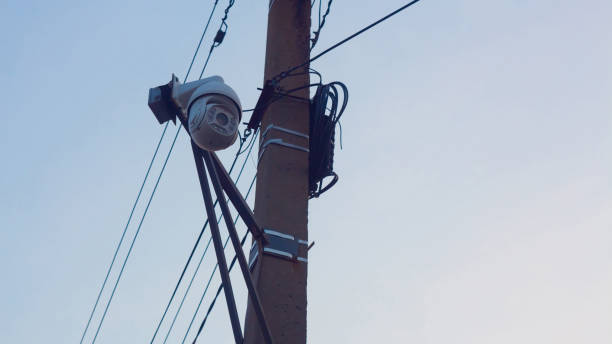 istock Tracking. Total control over people. Police surveillance.Security camera on the pole. Street video surveillance. eye of God. 1142639375