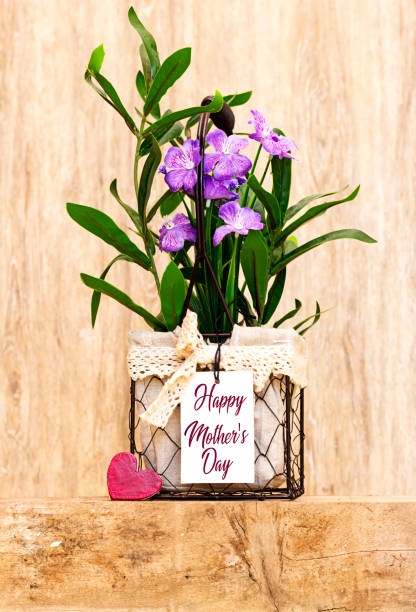 beautiful artificial purple flowers vase with happy mother's day tag and wooden heart on  cube beautiful artificial purple flowers vase with happy mother's day tag and wooden heart on  cube artificial flower stock pictures, royalty-free photos & images