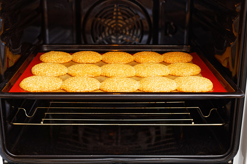 Closeup image of homemade sesame cookies baked in the kitchen oven