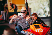Grandfather and grandson amusement park fun