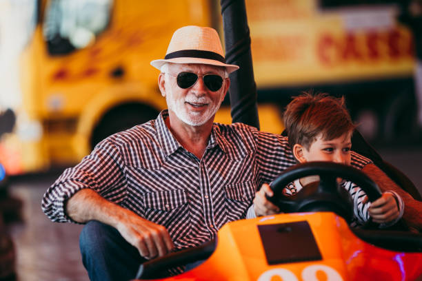 istock Grandfather and grandson amusement park fun 1142642370