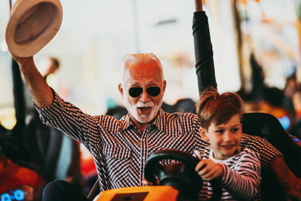 istock Grandfather and grandson amusement park fun 1142642407