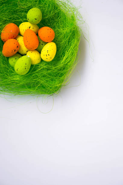 istock Green nest with colorful Easter eggs decoration on light purple background. Easter concept, holiday tradition top view with copy space for text 1142642569
