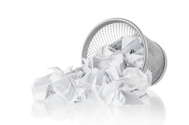 istock Rubbish bin and waste paper on white background 1142643627