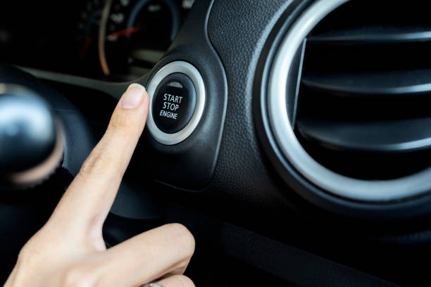 istock Using the push button to start and stop engine, The woman's finger is pressing down. 1142646170