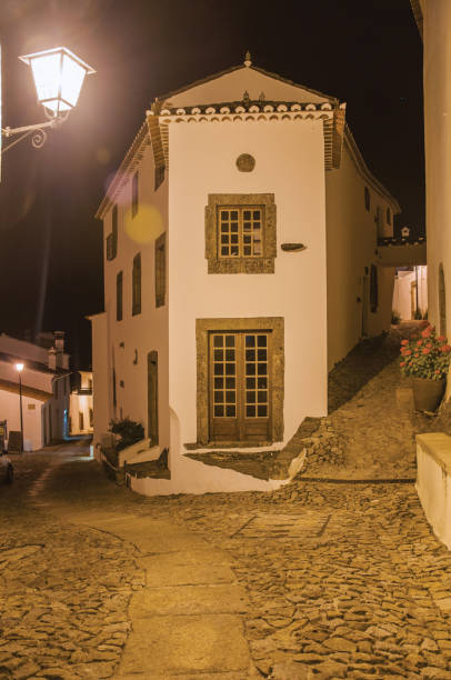 istock Old corner house in between two alleys at dusk in Marvao 1142646995