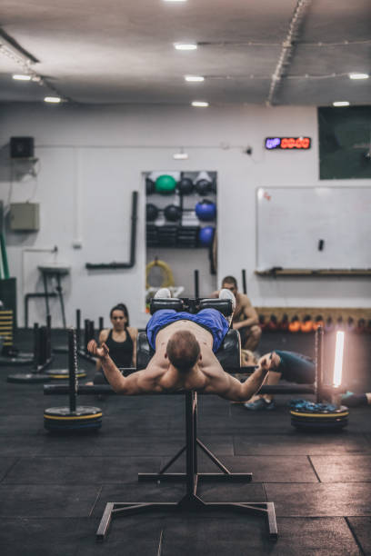 istock Male athlete doing sit ups on roman bench 1142648106