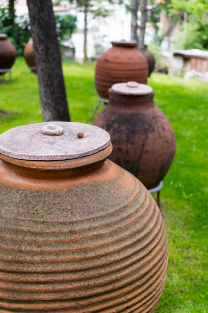 istock Large Old Earthenware Jars in Garden 1142649383