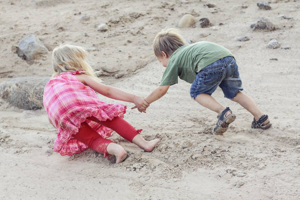 istock One child helping the other child. Help concept 1142650554