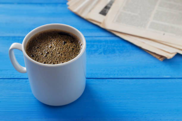istock Cup of coffee and old newspapers 1142651889
