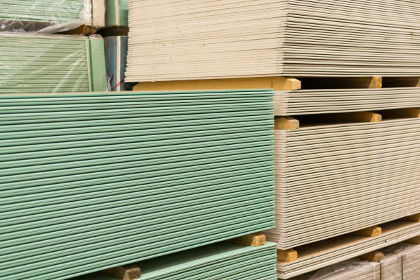 istock Gypsum plasterboard in the pack. The stack of gypsum board preparing for construction. Pallet with plasterboard in the building store. Construction Materials. Drywall warehouse. 1142652182