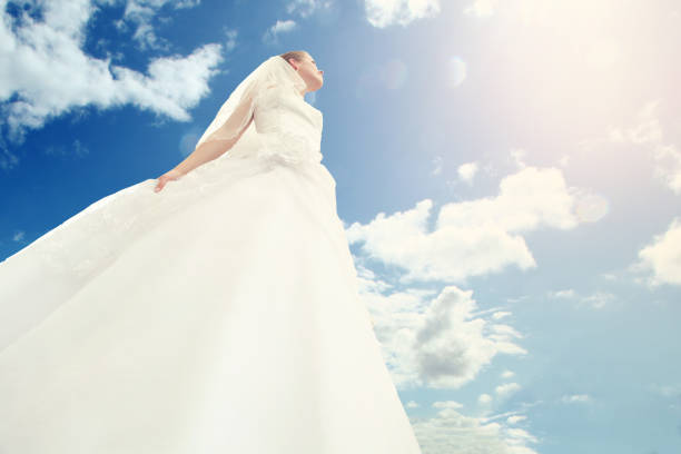 istock Young bride enjoying blue sky with sun 1142653237