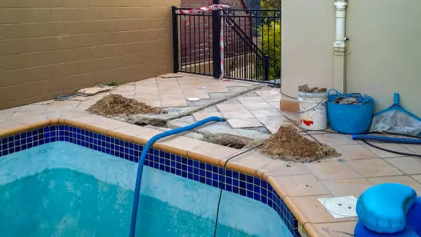 Swimming pool under repair construction with danger tap