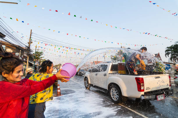 Thai people celebrating New Year Songkran Water Festival on the street in Sukhothai, Thailand stock photo