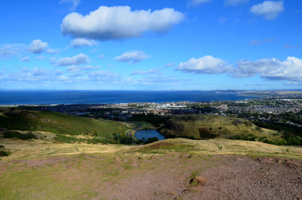 Puffy white clouds over Edingburgh Scotland.