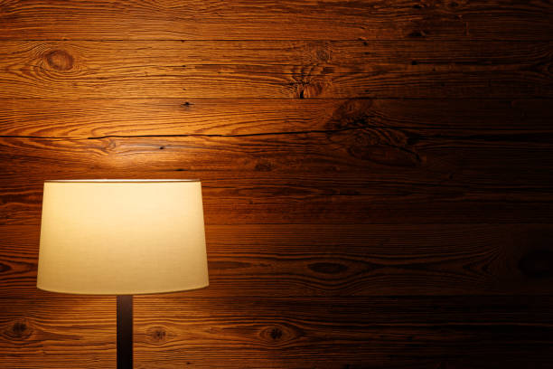 istock Indoor lighting by floor lamp at wooden wall 1142656775