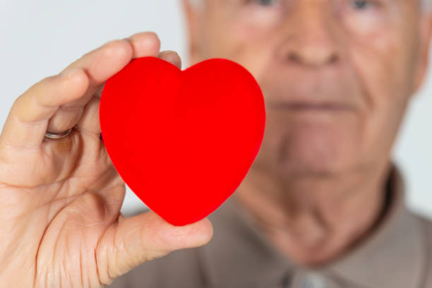 istock Elderly Man Holding Red Heart 1142658734
