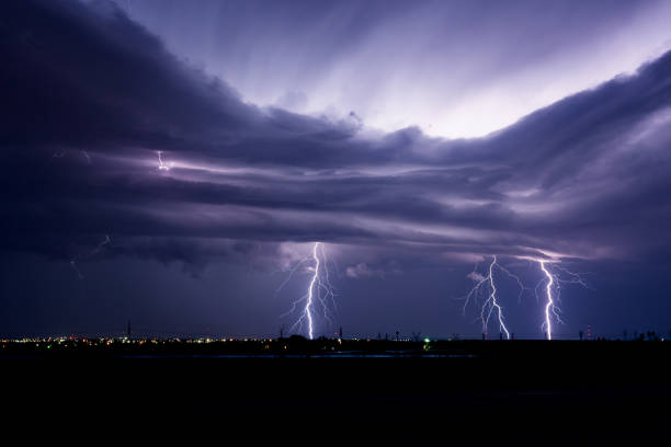 un rayo sobre una ciudad - lightning thunderstorm city storm fotografías e imágenes de stock