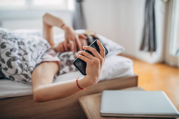 istock Tired woman is looking at smart phone 1142659792