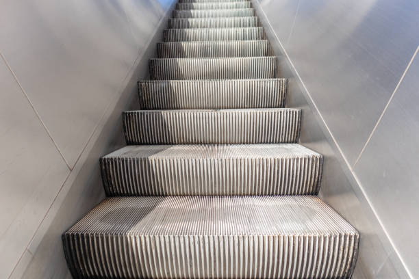 istock Empty electric escalators going up, stainless steel finishings, closeup view 1142659992