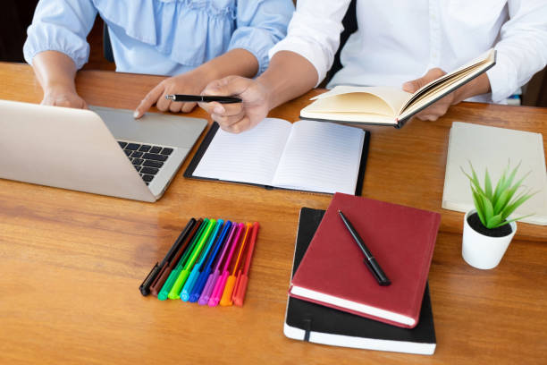 istock Tutor, learning, education, Group of young people learning studying lesson in library during helping teaching friend education prepare for exam, youth campus friendship teenager teens concept 1142660449