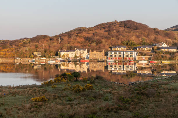 istock Pier and buildings reflected in Clifden bay 1142661659