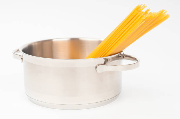 istock Dry spaghetti in stainless saucepan isolated on white background 1142664045
