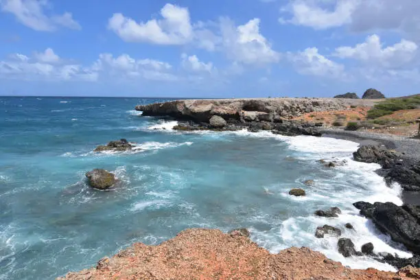 Aqua tropical waters off of Aruba's east coast and the black sand stone beach.