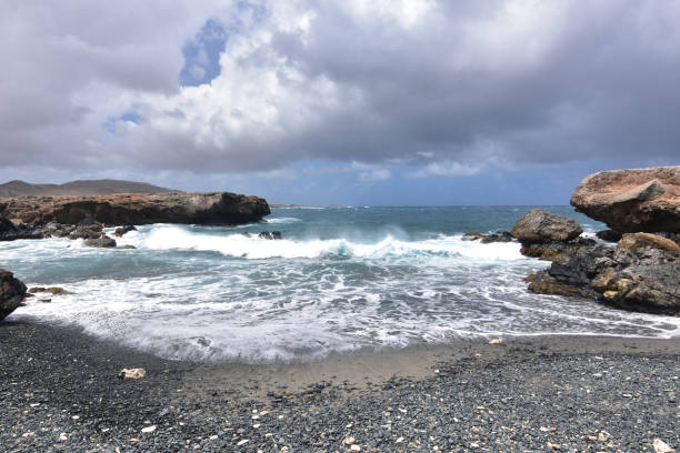 istock Stunning Black Sand Stone Beach in Aruba 1142664605