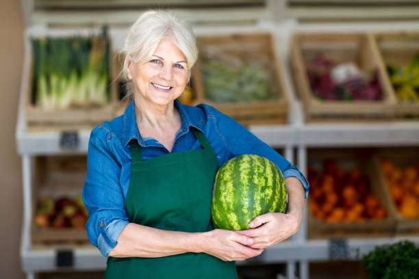 istock Senior woman working in small grocery store 1142665726