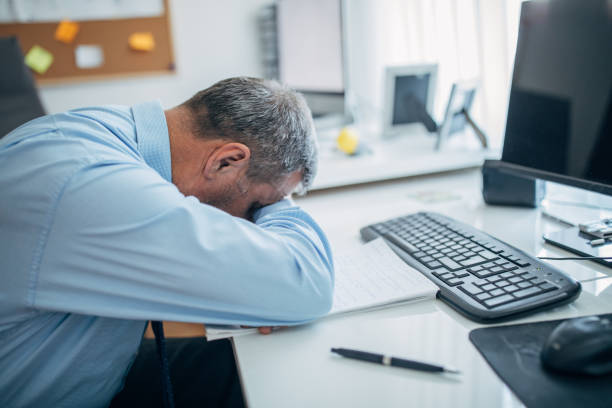 istock Tired senior businessman sleeping at the office 1142667009
