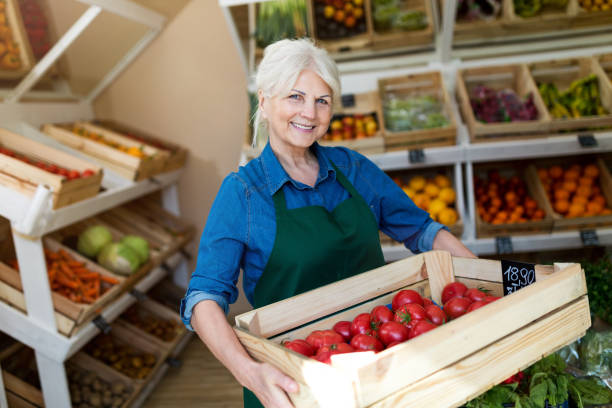 istock Senior woman working in small grocery store 1142669776