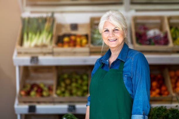 istock Senior woman working in small grocery store 1142669817
