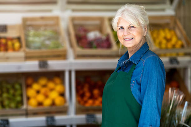 istock Senior woman working in small grocery store 1142669889