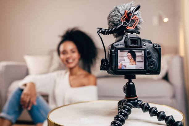 istock Close up of a DSLR camera mounted on a tripod. Vlogger filming a content. 1142670035