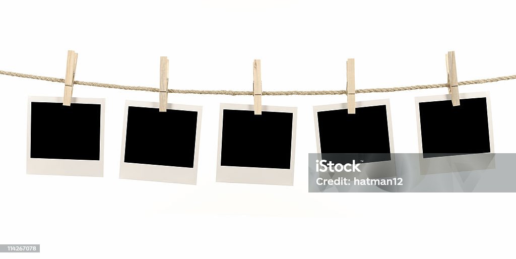 Blank polaroid pictures hanging on a clothes line Several blank instant photo prints hanging on a rope or washing line.   Alternative version of this file shown below: Instant Print Transfer Stock Photo