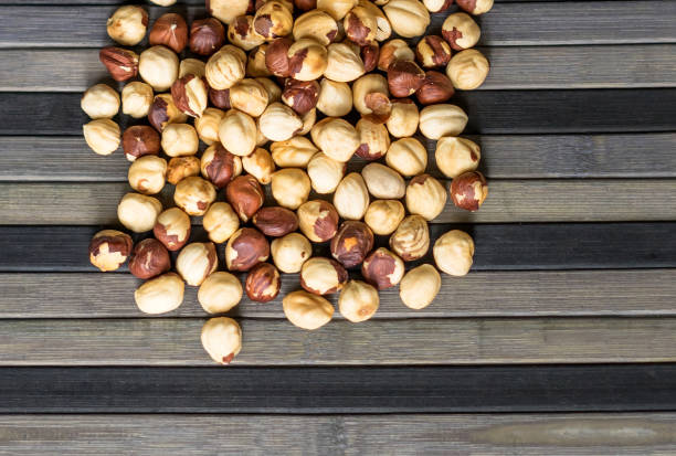istock Healthy food  for background image close up hazelnuts.  Nuts texture on top view on the cup plate 1142671986