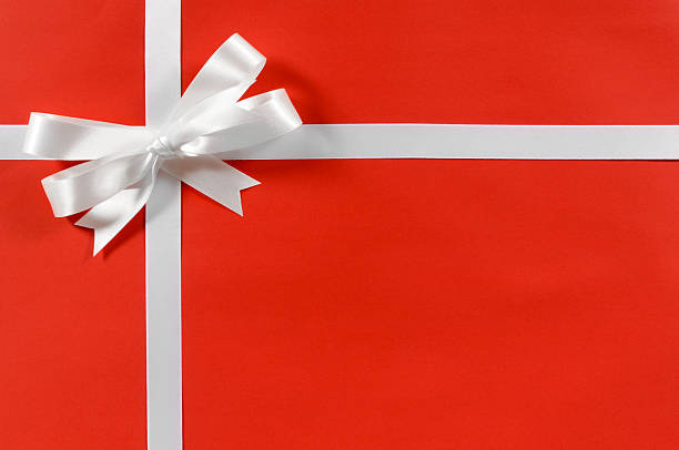 istock Red wrapping paper with white gift ribbon and a bow 114267286