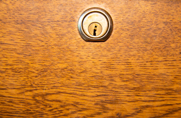istock The texture of the wooden surface with a keyhole. 1142673577