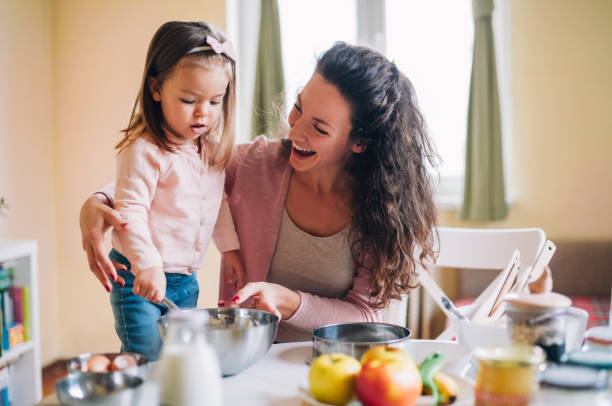 istock Happy mother and daughter in kitchen 1142674882