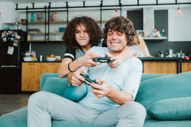 istock Father and son playing digital games at home 1142674924