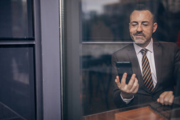 istock Smiling senior businessman having a video call 1142677628