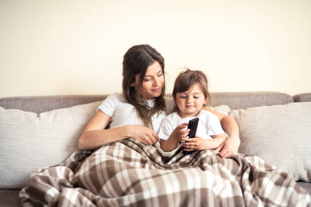 istock Mother and daughter watching television 1142677825