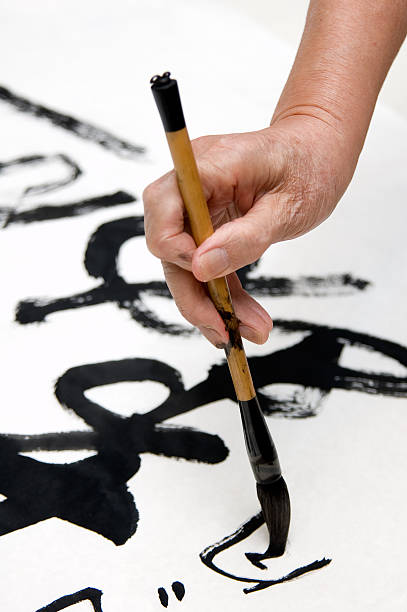 Hand with brush painting Chinese calligraphy Chinese Calligraphy writed by a old man chinese script photos stock pictures, royalty-free photos & images