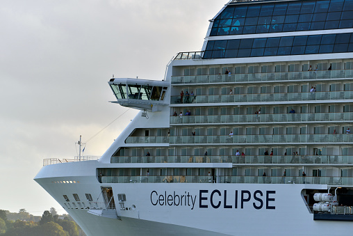 Sydney, Australia - March 15th, 2023: Sydney Harbor with Opera House, Harbor Bridge, Sydney Ferries, and Cruise ship “Celebrity Eclipse ” moored. Sunny day.