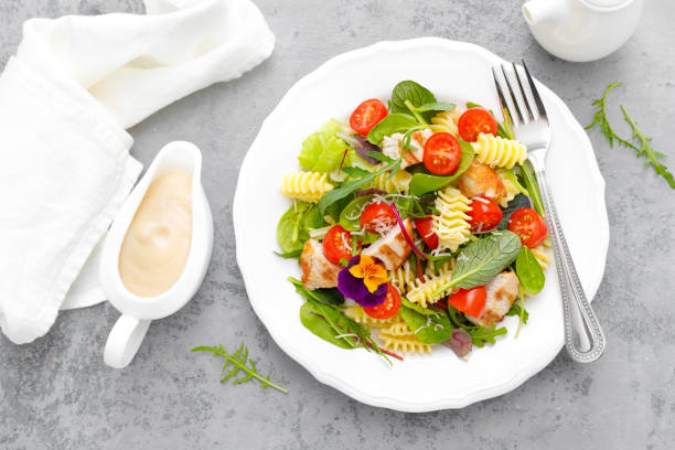 istock Pasta salad with grilled chicken meat, vegetables and cheese 1142682391