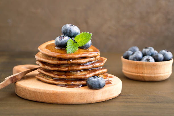 istock Chocolate pancakes with blueberries on a dark background. 1142682396