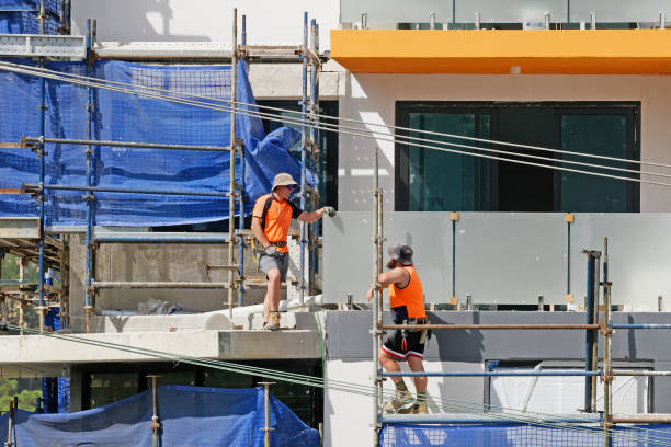 High angle view of project managers and team of workers working at construction site in blurred motion. Copy space.